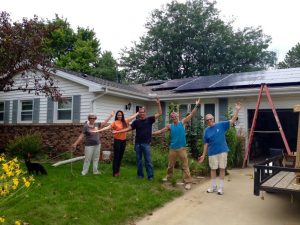 Group of Solar buyers in front of a home with solar